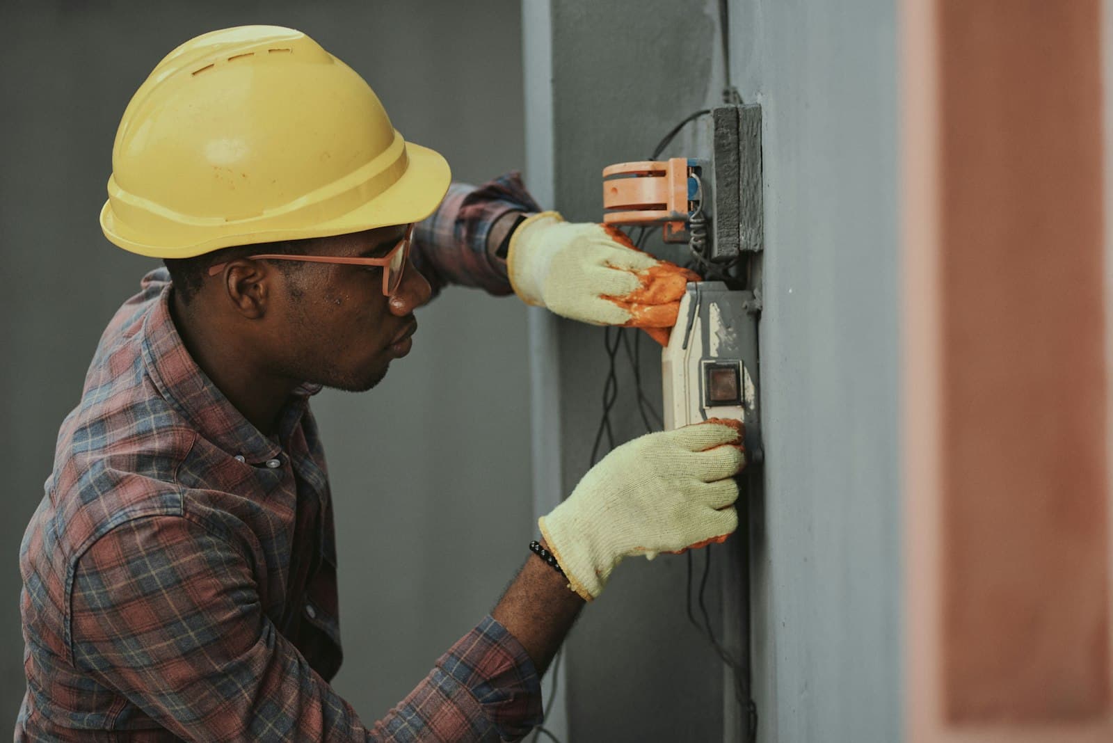 Electrician hands working on a switch — certified electrical work
