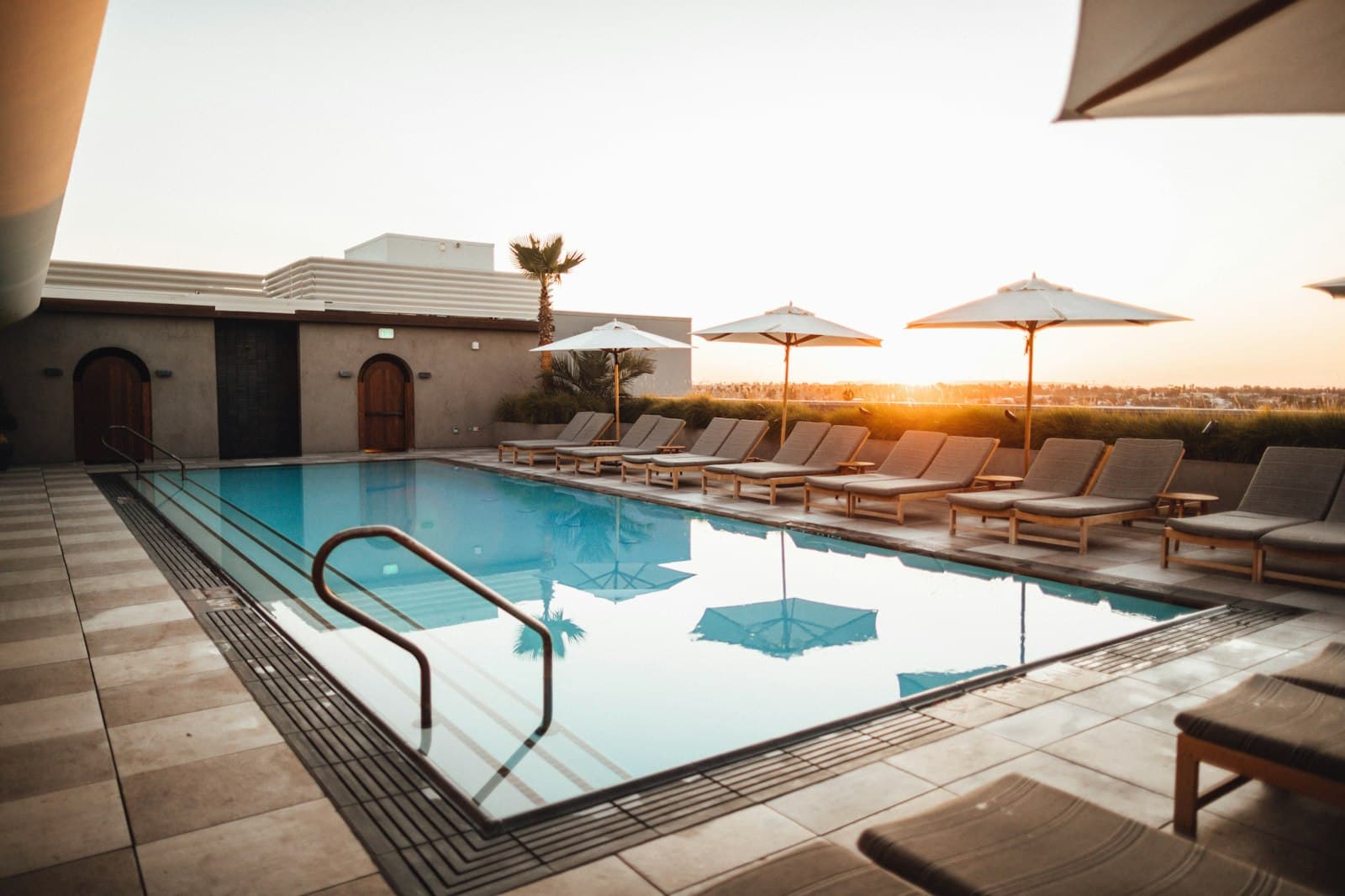 Calm sunlit pool with clean blue water — routine pool service look